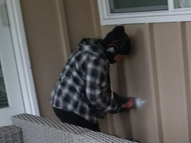 Professional electrician installing an exterior outlet in Dranesville